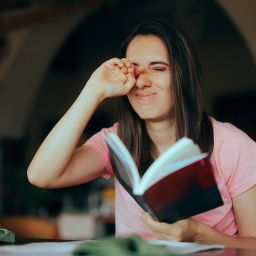 woman reading a book with dry eye