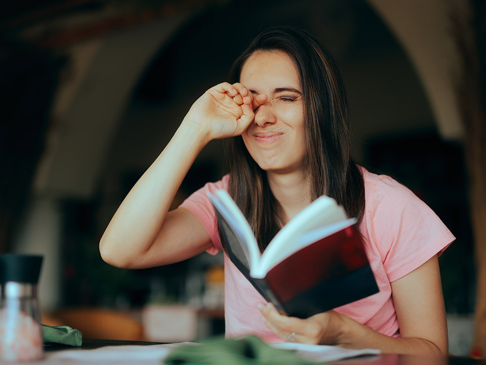 woman reading a book with dry eye