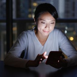 woman on her phone at night