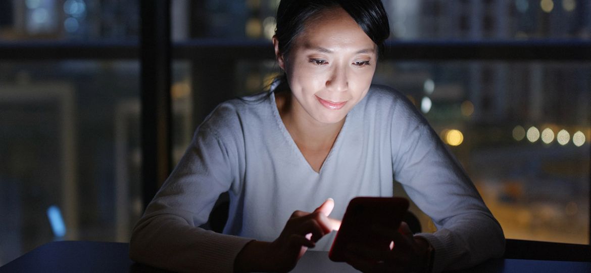 woman on her phone at night