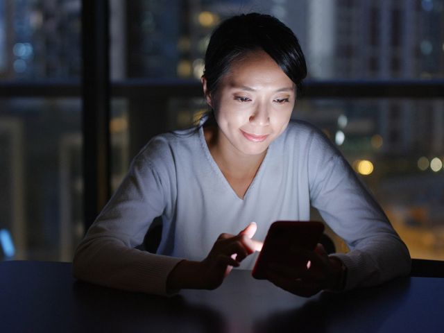 woman on her phone at night