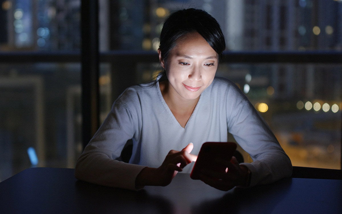 woman on her phone at night