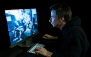 man playing video games on computer