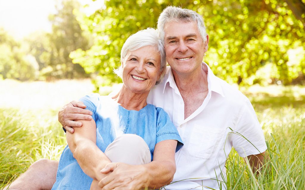 happy couple smiling outdoors
