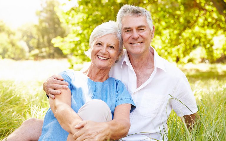 happy couple smiling outdoors