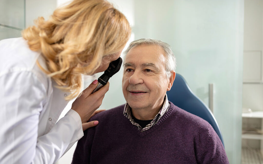 doctor with patient checking his eyes