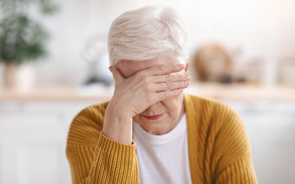 Senior woman suffering from migraine