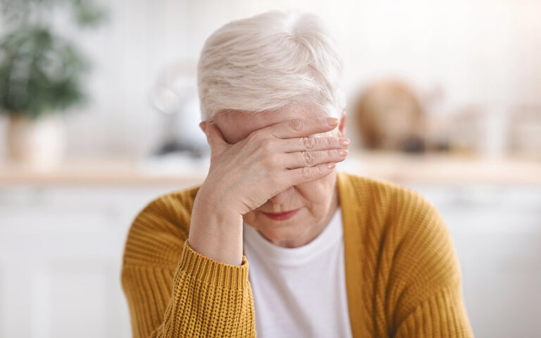 Senior woman suffering from migraine