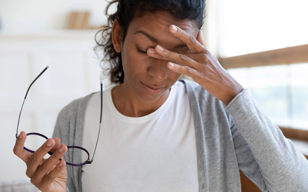 woman at home with eye pain
